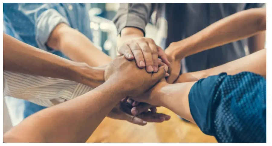 diverse hands clasping