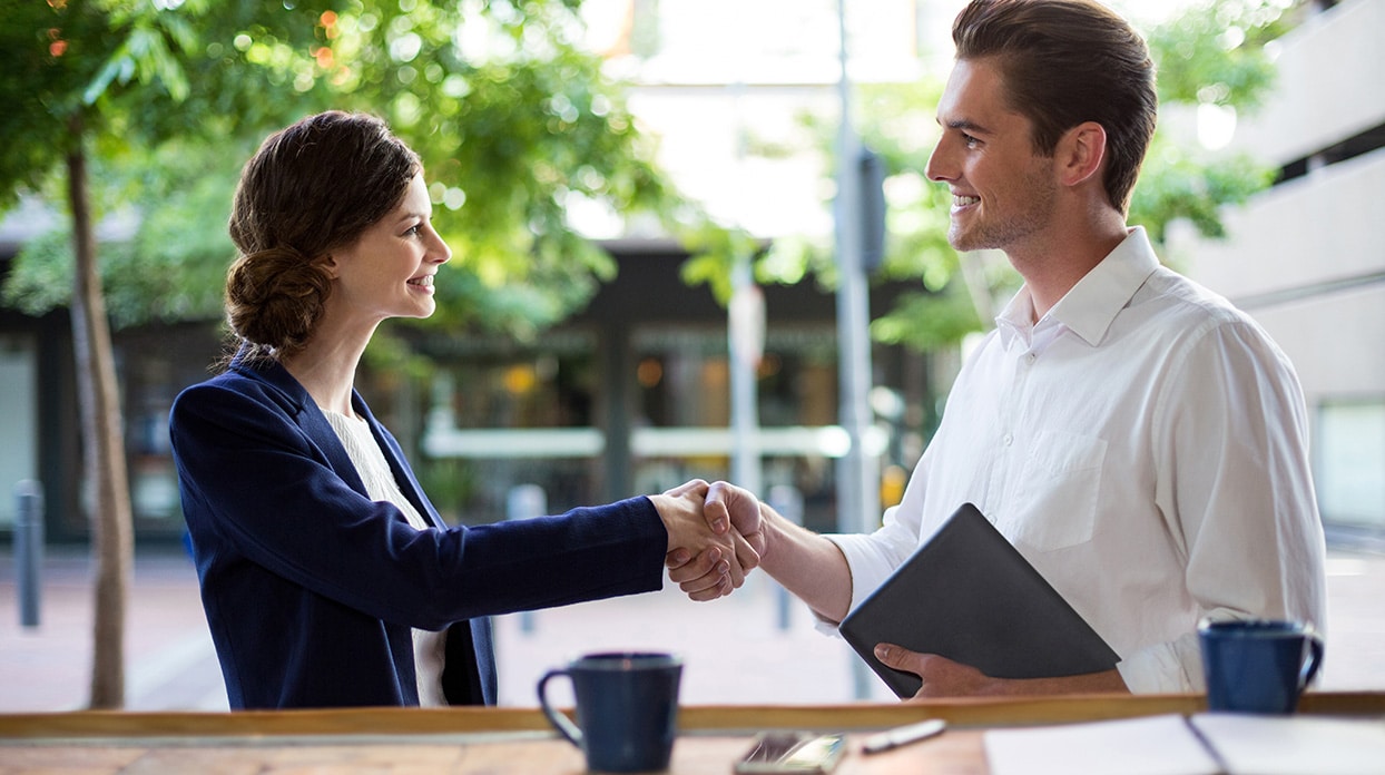 business woman and man shaking hands