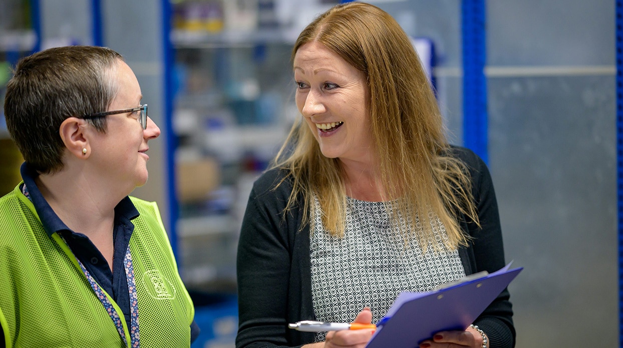 warehouse manager smiling at employee